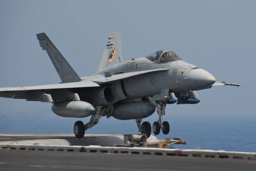 Scott in fighter jet taking off of an aircraft carrier