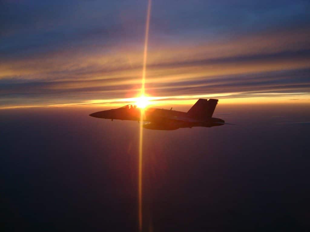 The sun going down behind Scott Kartvedt in a fighter jet