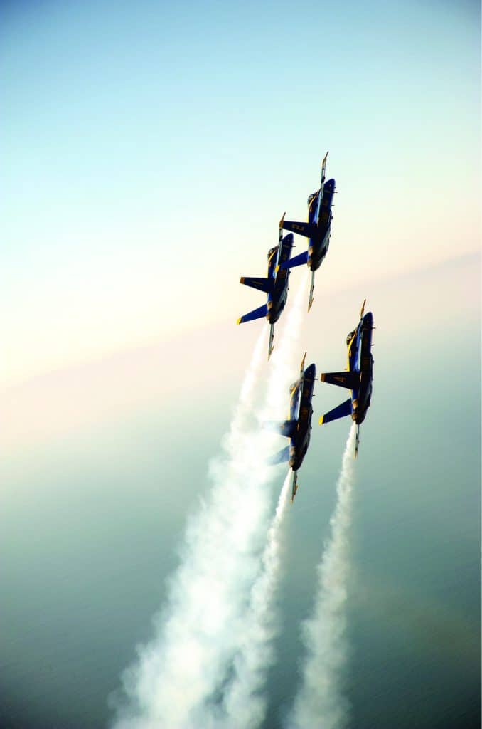 Angled photo of a team of 4 Navy Blue Angels