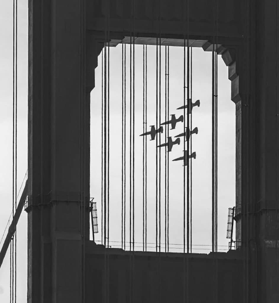 Patriots stunt jet team flying in formation, viewed through Golden Gate Bridge