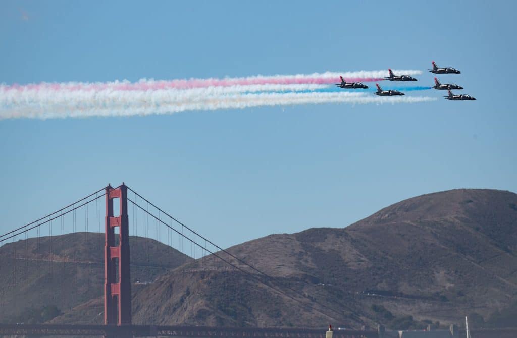 Patriots stunt jet team flying in formation, with the Golden Gate Bridge below them