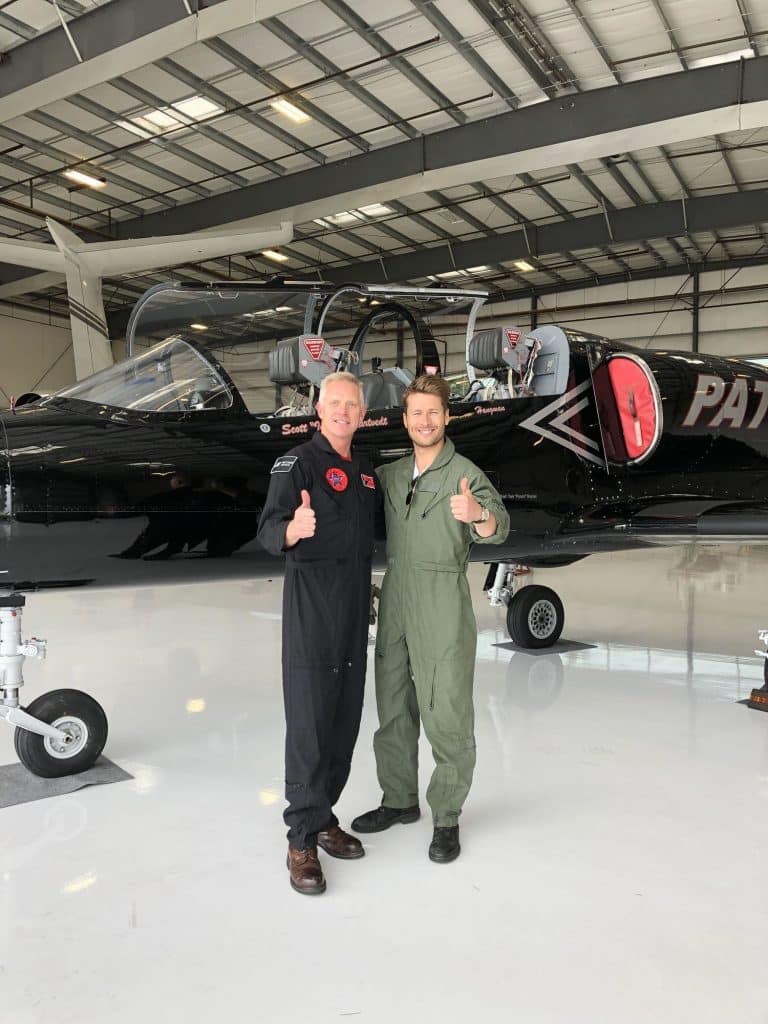 Scott Kartvedt and Glen Powell in hangar